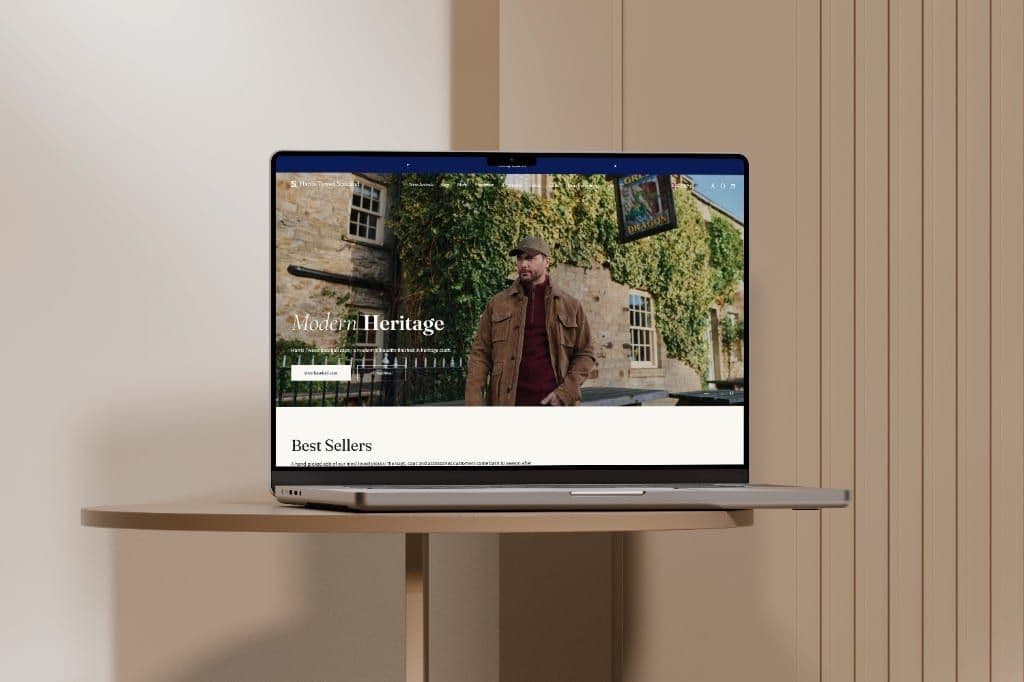 A laptop showing the Harris Tweed Scotland homepage, with the Modern Heritage photograph