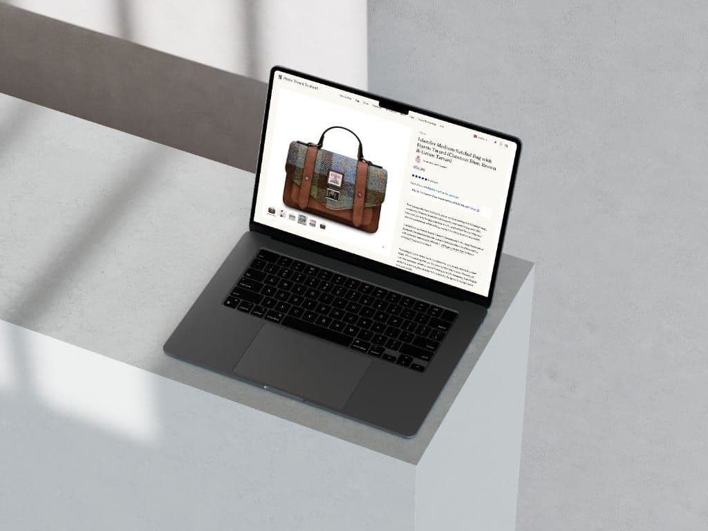 A laptop showing an Islander medium satchel in Harris Tweed on the product page
